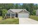 Charming single-story home with a well-manicured lawn, two-car garage, and welcoming front entrance at 145 Bounding Ln, Youngsville, NC 27596