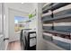 Bright laundry room with modern washer and dryer, shelving, and natural light from the window at 145 Bounding Ln, Youngsville, NC 27596