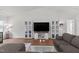 Stylish living room showcasing an entertainment center with barn door accents and vaulted ceiling at 145 Bounding Ln, Youngsville, NC 27596