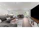 Comfortable living space with a large TV, modern furnishings, and bright windows offering natural light at 145 Bounding Ln, Youngsville, NC 27596