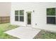 Back exterior elevation featuring a cement patio and glass door at 157 Lynn Dr, Clayton, NC 27520