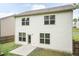 Back exterior elevation featuring a cement patio, door and many windows at 157 Lynn Dr, Clayton, NC 27520