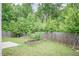 View of a backyard with a wooden fence and a raised garden bed at 157 Lynn Dr, Clayton, NC 27520