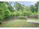 Backyard view showcasing a well-maintained lawn, garden, and privacy fence at 157 Lynn Dr, Clayton, NC 27520
