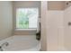 Bright bathroom boasts a soaking tub, shower, and window for natural light at 157 Lynn Dr, Clayton, NC 27520
