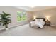 Bright bedroom with a large window, neutral colors, and comfortable furnishings at 157 Lynn Dr, Clayton, NC 27520