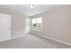 Bedroom featuring a window and plush carpet at 157 Lynn Dr, Clayton, NC 27520