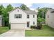 Charming two-story home featuring an attached garage, landscaping, and neutral color scheme at 157 Lynn Dr, Clayton, NC 27520