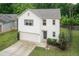 Two-story home with a gray roof, lush lawn, attached garage, and complemented by tall shade trees at 157 Lynn Dr, Clayton, NC 27520