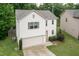 Home featuring a manicured lawn, garage, a modern roof, and a cozy backyard area with shade trees at 157 Lynn Dr, Clayton, NC 27520