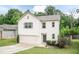 Well-maintained home featuring an attached garage, mature trees, and a cozy, welcoming appearance at 157 Lynn Dr, Clayton, NC 27520