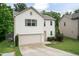 Two-story home with an attached garage and a classic design, complemented by a well-manicured lawn at 157 Lynn Dr, Clayton, NC 27520