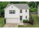 Inviting two-story house with attached garage, mature landscaping, and a well-kept front yard at 157 Lynn Dr, Clayton, NC 27520