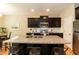 Well-lit kitchen with a granite countertop island, stainless steel appliances, and dark wood cabinets at 157 Lynn Dr, Clayton, NC 27520