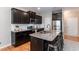 Modern kitchen features a granite countertop island, stainless steel appliances, and dark wood cabinets at 157 Lynn Dr, Clayton, NC 27520