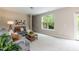 Bright living room featuring neutral colors, comfortable seating, and a large window at 157 Lynn Dr, Clayton, NC 27520