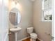 Powder room with a pedestal sink, toilet, and window at 157 Lynn Dr, Clayton, NC 27520