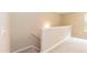 Neutral stairway landing with carpet and wooden railing at 157 Lynn Dr, Clayton, NC 27520