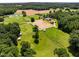 Aerial view of a horse farm featuring green pastures and an outdoor arena at 1624 Hopkins Rd, Bahama, NC 27503