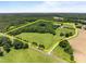 Aerial view of large property including fields, woods, and pastures with surrounding yellow property line at 1624 Hopkins Rd, Bahama, NC 27503