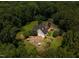 Stunning aerial view of a home nestled among lush greenery, complete with a backyard patio at 1624 Hopkins Rd, Bahama, NC 27503
