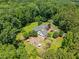 Breathtaking aerial view of a home surrounded by lush trees, featuring a stone patio at 1624 Hopkins Rd, Bahama, NC 27503