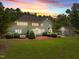 Expansive backyard featuring a brick patio, a screen porch, and mature trees at 1624 Hopkins Rd, Bahama, NC 27503