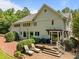 Inviting backyard with a brick patio, outdoor seating, and lush greenery at 1624 Hopkins Rd, Bahama, NC 27503
