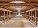 View of a large, unfinished barn area with wooden beams and natural light at 1624 Hopkins Rd, Bahama, NC 27503