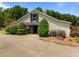Exterior view of the barn with decorative shutters and well manicured landscaping at 1624 Hopkins Rd, Bahama, NC 27503