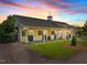 Beautiful barn featuring sunset views, horse stalls, and well-maintained landscaping at 1624 Hopkins Rd, Bahama, NC 27503