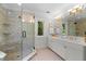 Elegant bathroom with glass shower enclosure, dual sink vanity with vintage fixtures and lighting at 1624 Hopkins Rd, Bahama, NC 27503