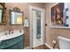 A decorative powder room featuring a turquoise vanity, unique fixtures, and wood flooring at 1624 Hopkins Rd, Bahama, NC 27503