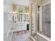 Bright bathroom featuring double sinks, white cabinets, and a tiled walk-in shower at 1624 Hopkins Rd, Bahama, NC 27503