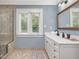 Light and airy bathroom with walk-in shower, window and large vanity at 1624 Hopkins Rd, Bahama, NC 27503