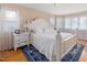 Comfortable bedroom with hardwood floors, a large bed, and natural light from multiple windows at 1624 Hopkins Rd, Bahama, NC 27503