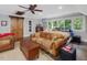 Large bonus room with comfortable seating, exposed beams and hardwood floors at 1624 Hopkins Rd, Bahama, NC 27503