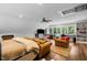Inviting bonus room with exposed beams, hardwood floors, and multiple seating areas at 1624 Hopkins Rd, Bahama, NC 27503