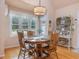 Charming dining area with natural light, a round table, and views of the backyard at 1624 Hopkins Rd, Bahama, NC 27503
