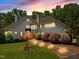 Elegant two-story home featuring well-lit landscaping and a brick walkway at 1624 Hopkins Rd, Bahama, NC 27503