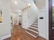 Open foyer featuring hardwood floors, staircase, and access to the kitchen and living area at 1624 Hopkins Rd, Bahama, NC 27503