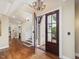 Elegant foyer with hardwood floors, staircase, and view of the front door with brick surround at 1624 Hopkins Rd, Bahama, NC 27503