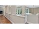 Second floor hallway with natural lighting and decorative railing overlooking the landscaped yard at 1624 Hopkins Rd, Bahama, NC 27503