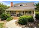Charming home with a landscaped front yard, inviting porch, and classic architectural details at 1624 Hopkins Rd, Bahama, NC 27503