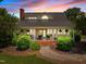 Inviting home exterior with a front porch, manicured landscaping, and a cozy ambiance at 1624 Hopkins Rd, Bahama, NC 27503