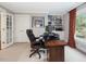 Comfortable home office with large window, built-in shelving and ample workspace at 1624 Hopkins Rd, Bahama, NC 27503