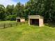 Horse shelters in a pasture with wooden fencing in a tranquil environment at 1624 Hopkins Rd, Bahama, NC 27503