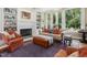Cozy living room featuring a fireplace, built-in shelves, and comfortable seating near bright windows at 1624 Hopkins Rd, Bahama, NC 27503