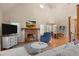 Bright living room with a brick fireplace, large windows, hardwood floors, and a comfortable sofa at 1624 Hopkins Rd, Bahama, NC 27503