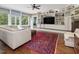 Bright living room with built-in entertainment center, fireplace, and seamless indoor/outdoor connection at 1624 Hopkins Rd, Bahama, NC 27503
